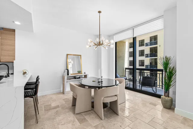 a kitchen with stainless steel appliances a refrigerator a sink and wooden cabinets