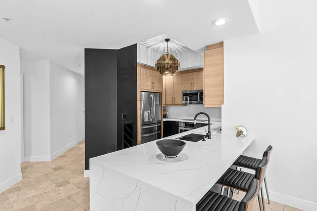 a living room with furniture a bookshelf and a window
