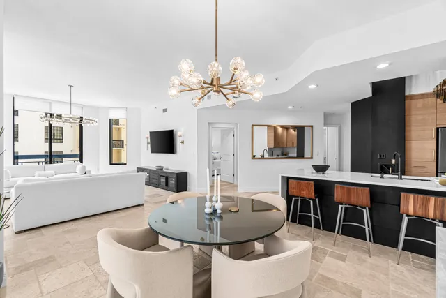 a kitchen with a table and refrigerator