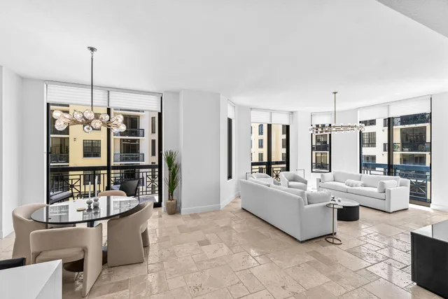 a kitchen with a sink a stove and chairs