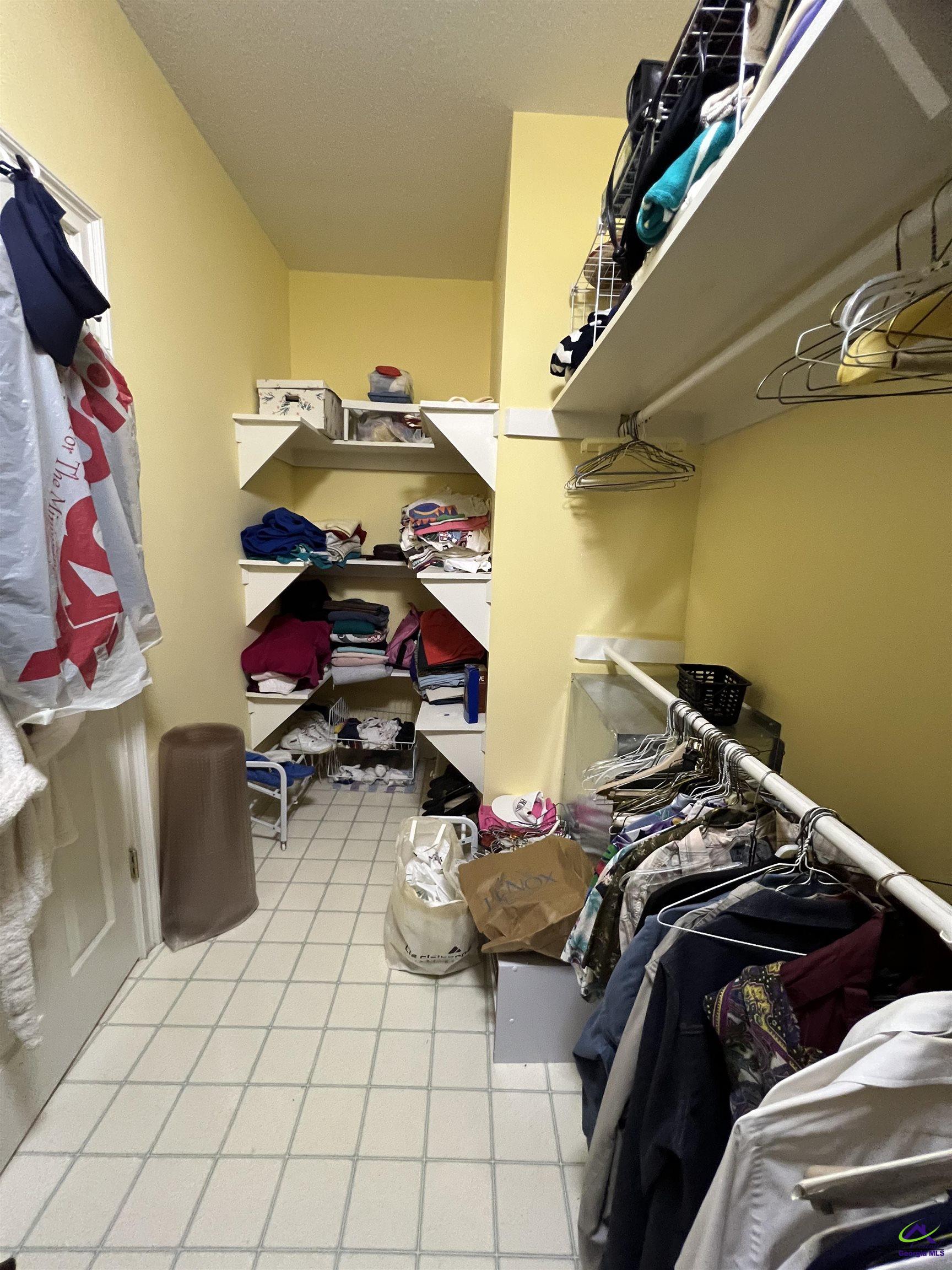 762 Nicholson-Carr Road Chester, GA 31012 - Photo 30 of 81 a view of walk in closet with clothes and shoes
