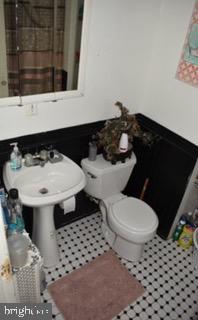 32 Springton Road Upper Darby, PA 19082 - Photo 7 of 9 a bathroom with a sink toilet and window