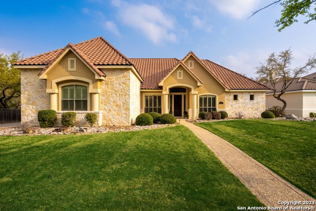 864 Hansen Greens San Antonio, TX 78260 - Photo 1 of 65 a front view of a house with a yard