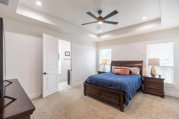 a bedroom with a bed and a large window