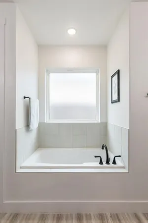 a bathroom with a bathtub and a window