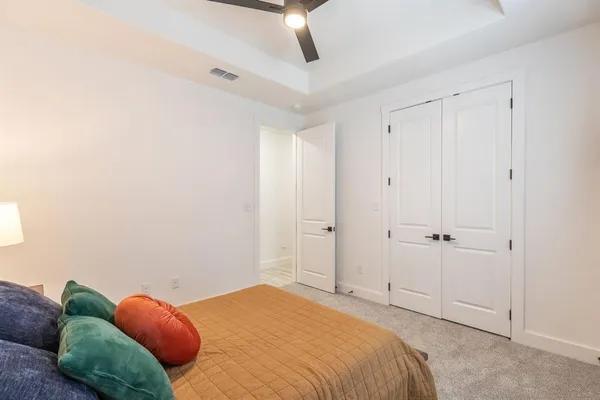 a bedroom with a bed and hallway