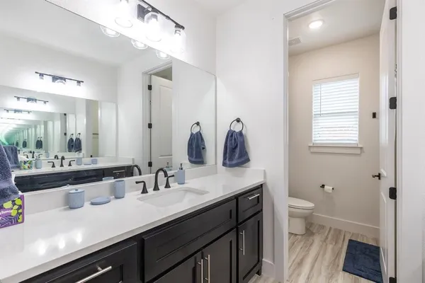 a view of bathroom with a sink mirror and toilet