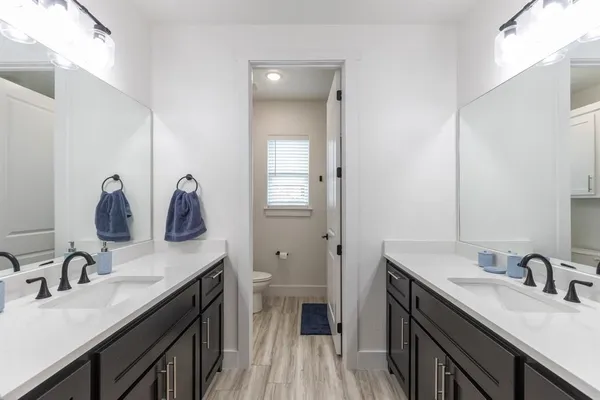 a bathroom with a sink double vanity and a toilet