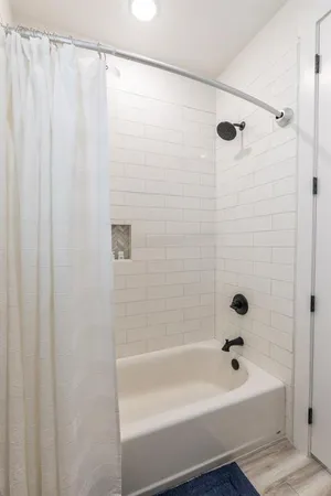 a bathroom with a shower and a bath tub