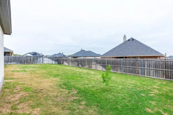 a view of yard with swimming pool and green space