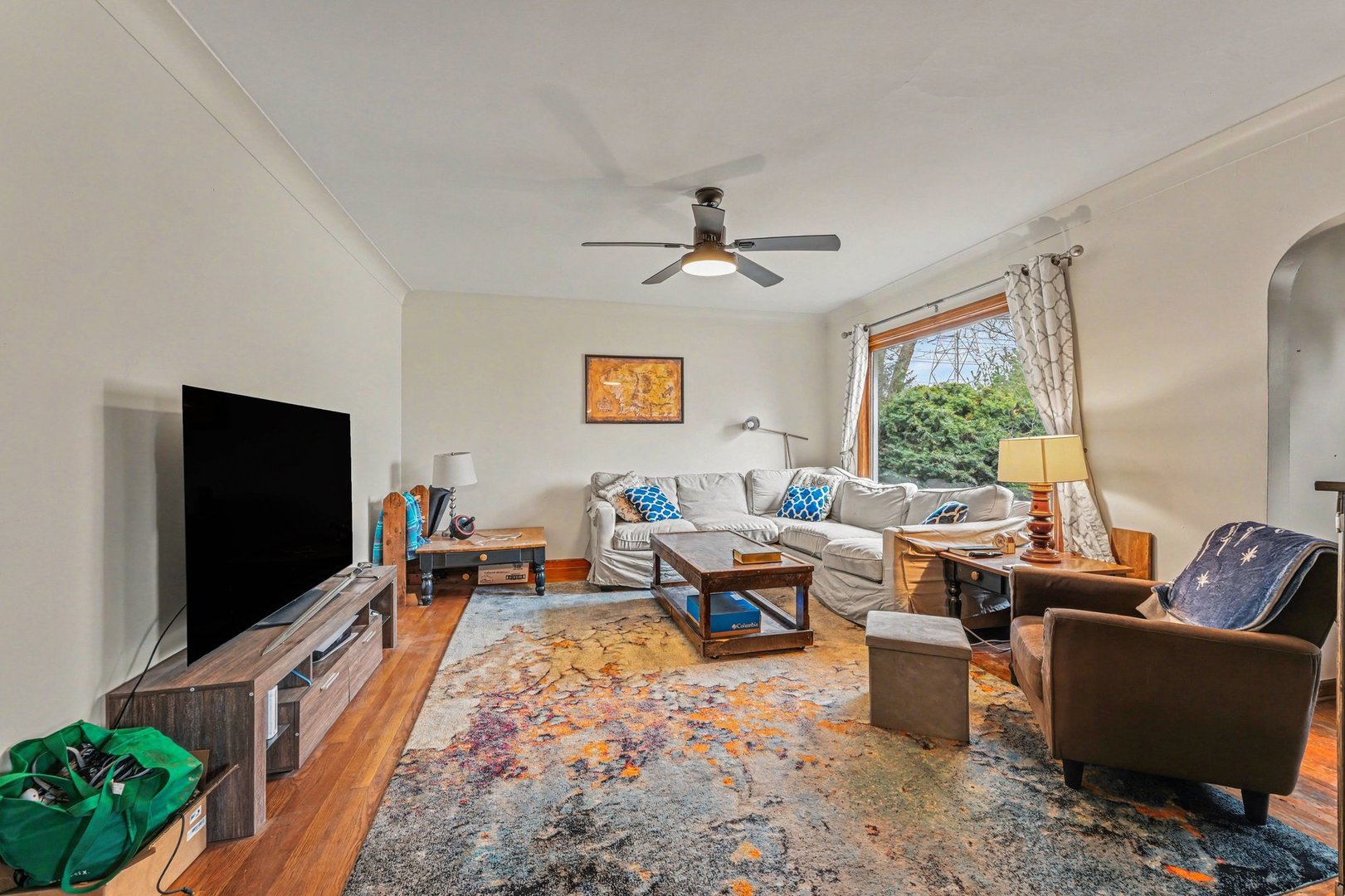 1999 Indiana Avenue Lansing, IL 60438 - Photo 4 of 18 a living room with furniture floor to ceiling window and a flat screen tv