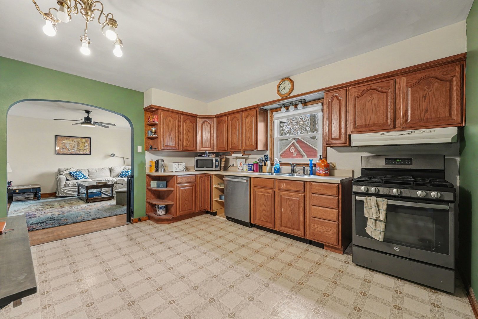 1999 Indiana Avenue Lansing, IL 60438 - Photo 7 of 18 a kitchen with granite countertop a stove top oven sink and cabinets