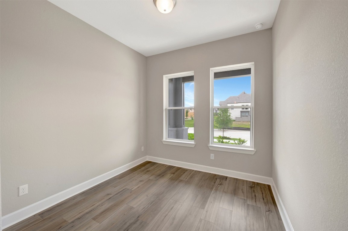 2423 Msn Hts Way Manvel, TX 77578 - Photo 14 of 49 an empty room with wooden floor and windows