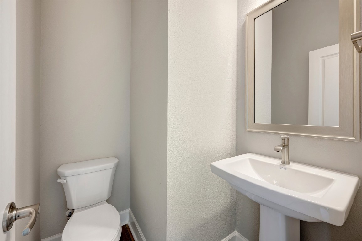2423 Msn Hts Way Manvel, TX 77578 - Photo 19 of 49 a bathroom with a toilet sink and mirror