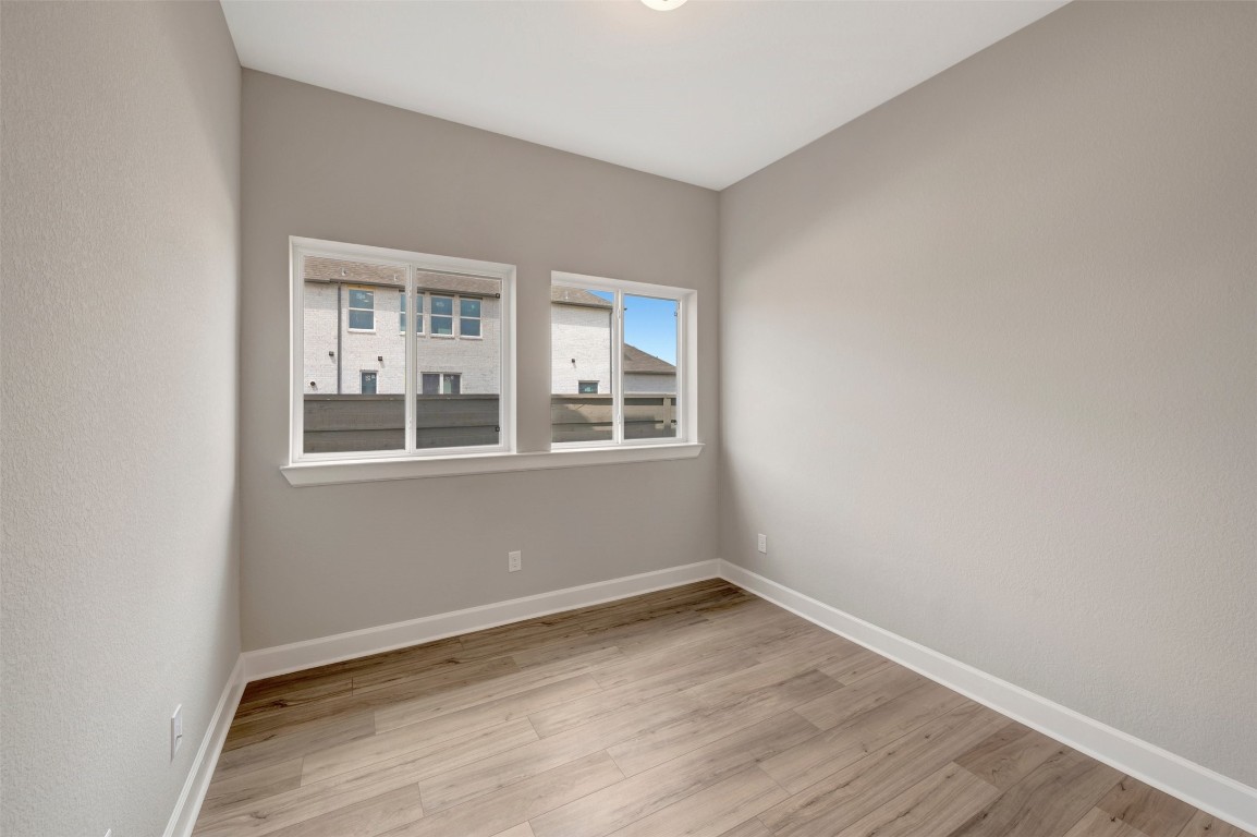 2423 Msn Hts Way Manvel, TX 77578 - Photo 20 of 49 a view of empty room with wooden floor and fan