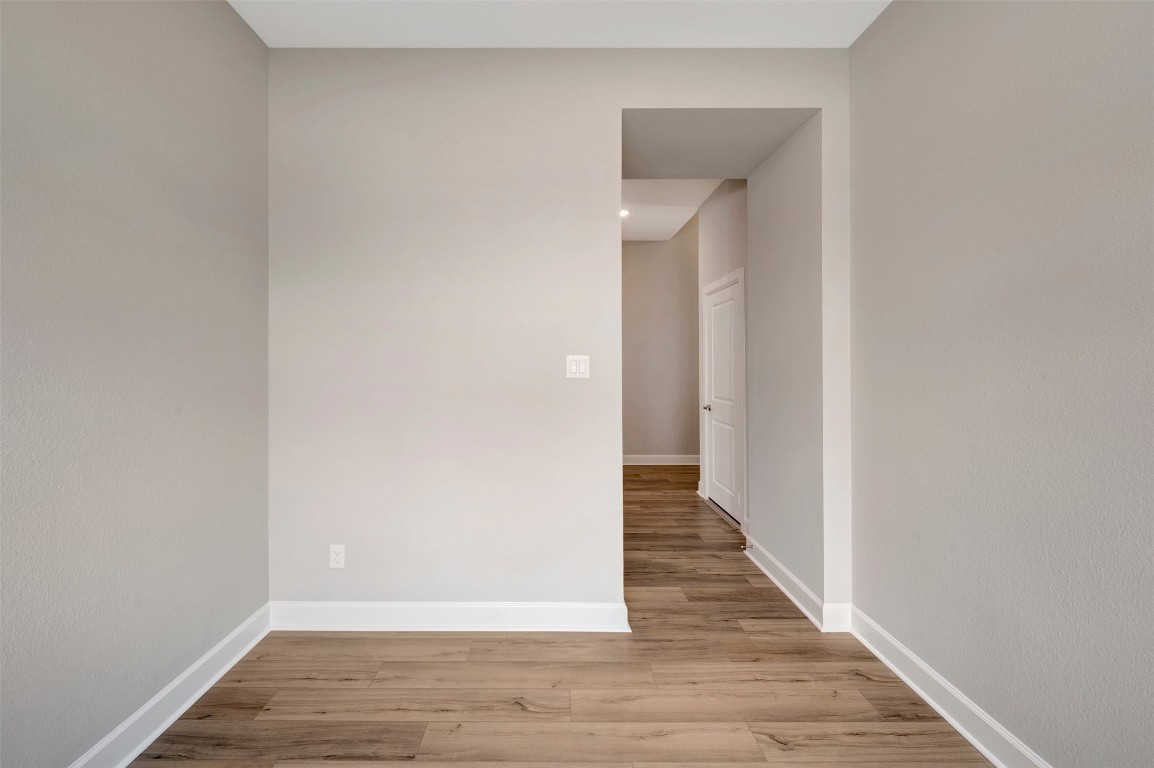 2423 Msn Hts Way Manvel, TX 77578 - Photo 21 of 49 a view of a hallway with wooden floor