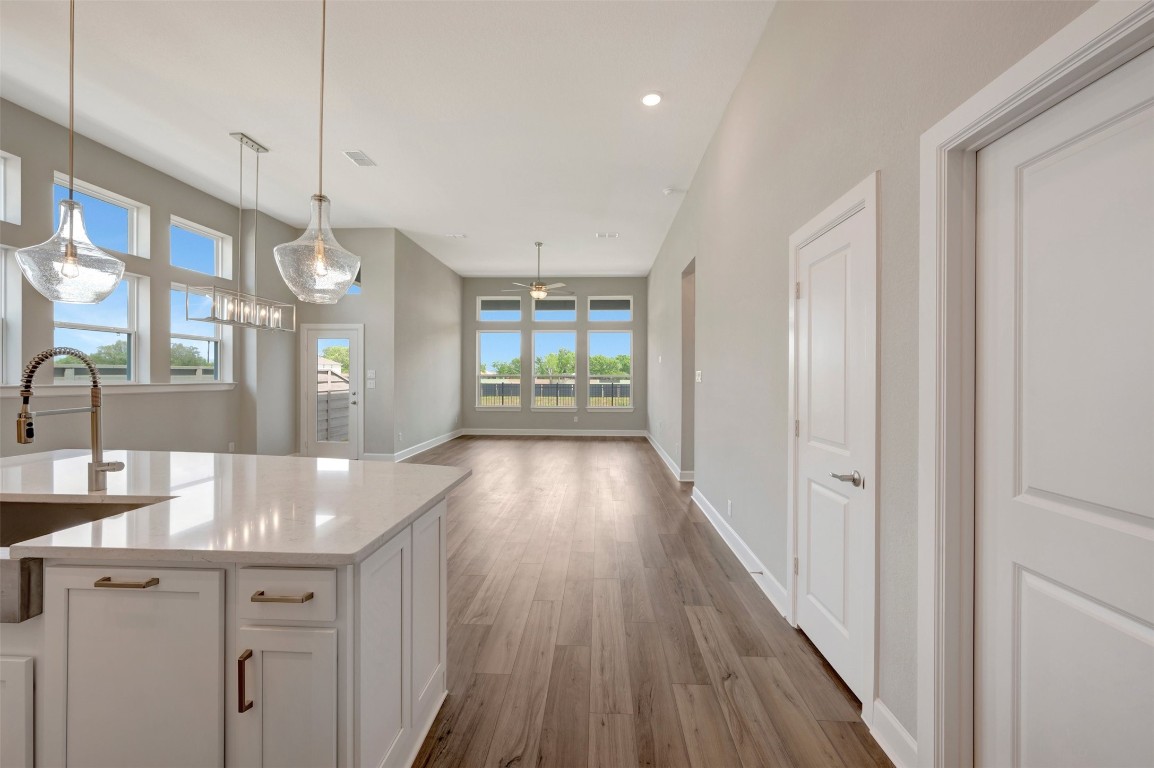 2423 Msn Hts Way Manvel, TX 77578 - Photo 23 of 49 a view of a hallway with wooden floor and a living room