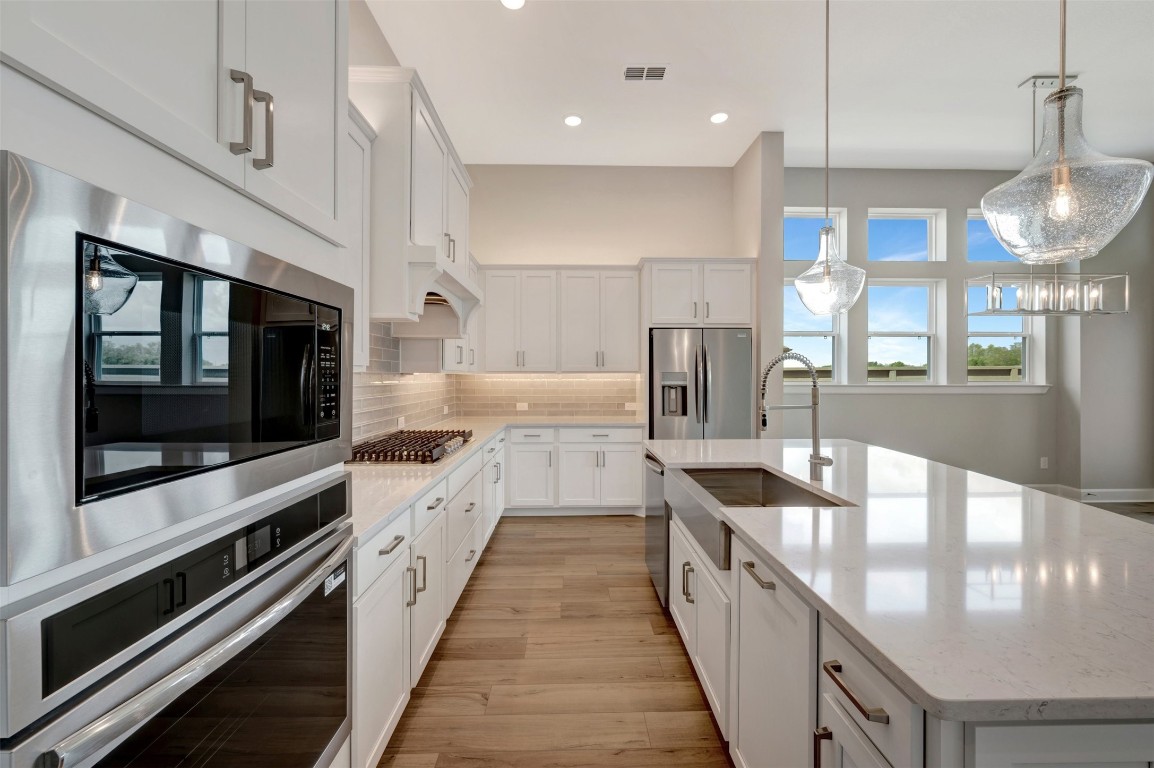 2423 Msn Hts Way Manvel, TX 77578 - Photo 24 of 49 a large kitchen with stainless steel appliances