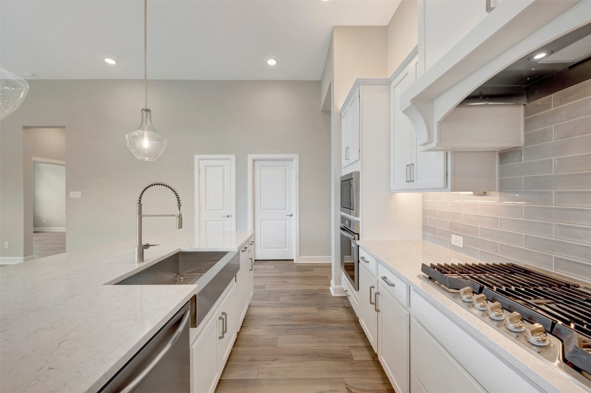 2423 Msn Hts Way Manvel, TX 77578 - Photo 29 of 49 a kitchen with a stove and a sink
