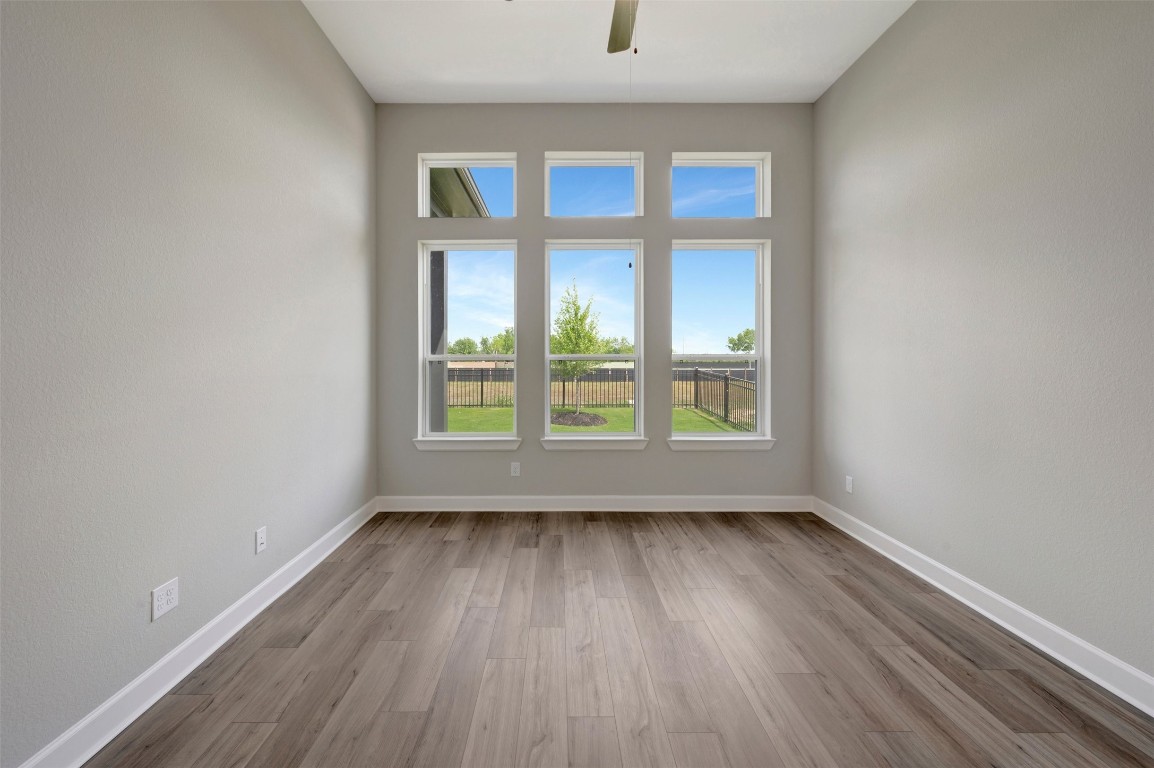 2423 Msn Hts Way Manvel, TX 77578 - Photo 37 of 49 an empty room with wooden floor and windows