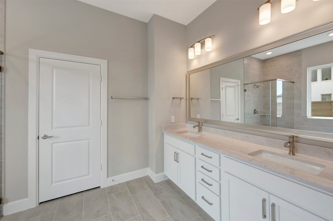 2423 Msn Hts Way Manvel, TX 77578 - Photo 41 of 49 a bathroom with a double vanity sink and a mirror