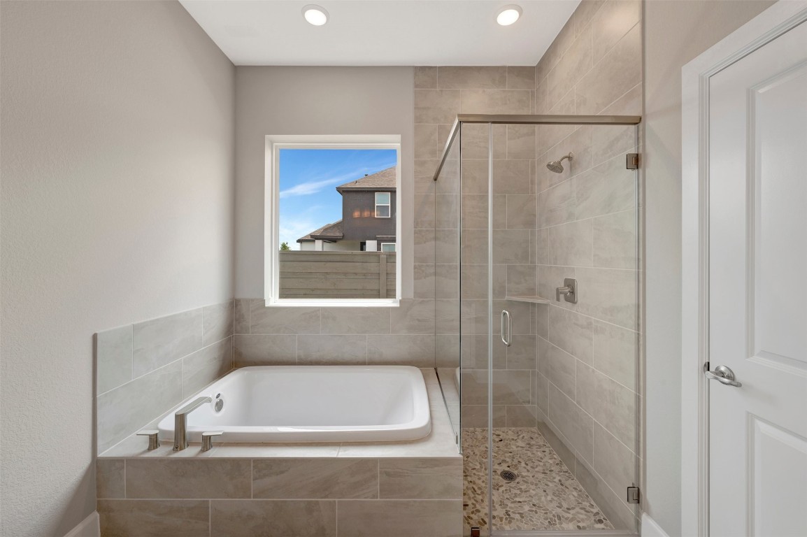 2423 Msn Hts Way Manvel, TX 77578 - Photo 42 of 49 a bathroom with a tub a rug and a shower