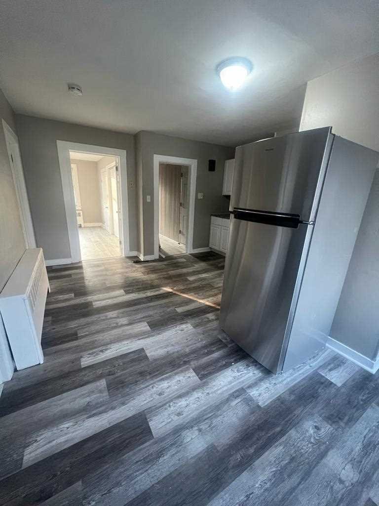 24-26 Spring Street, Unit 2 Wappingers Falls, NY 12590 - Photo 2 of 7 a view of a livingroom with wooden floor and a refrigerator