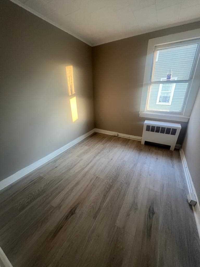 24-26 Spring Street, Unit 2 Wappingers Falls, NY 12590 - Photo 6 of 7 a view of an empty room with wooden floor and a window