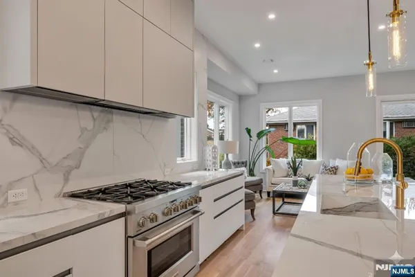 a kitchen with granite countertop a stove and a sink