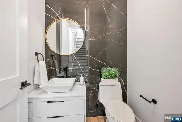 a bathroom with a sink toilet and a mirror