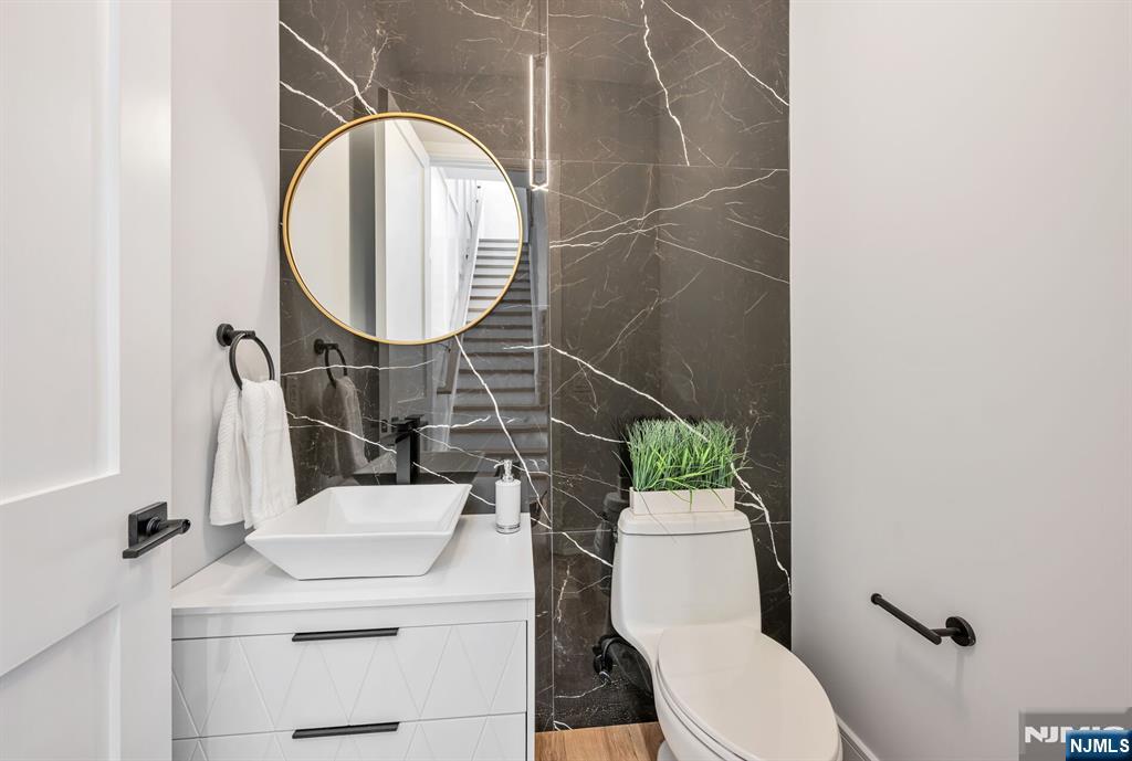 2449 Camner Street Fort Lee, NJ 07024 - Photo 20 of 49 a bathroom with a sink toilet and a mirror