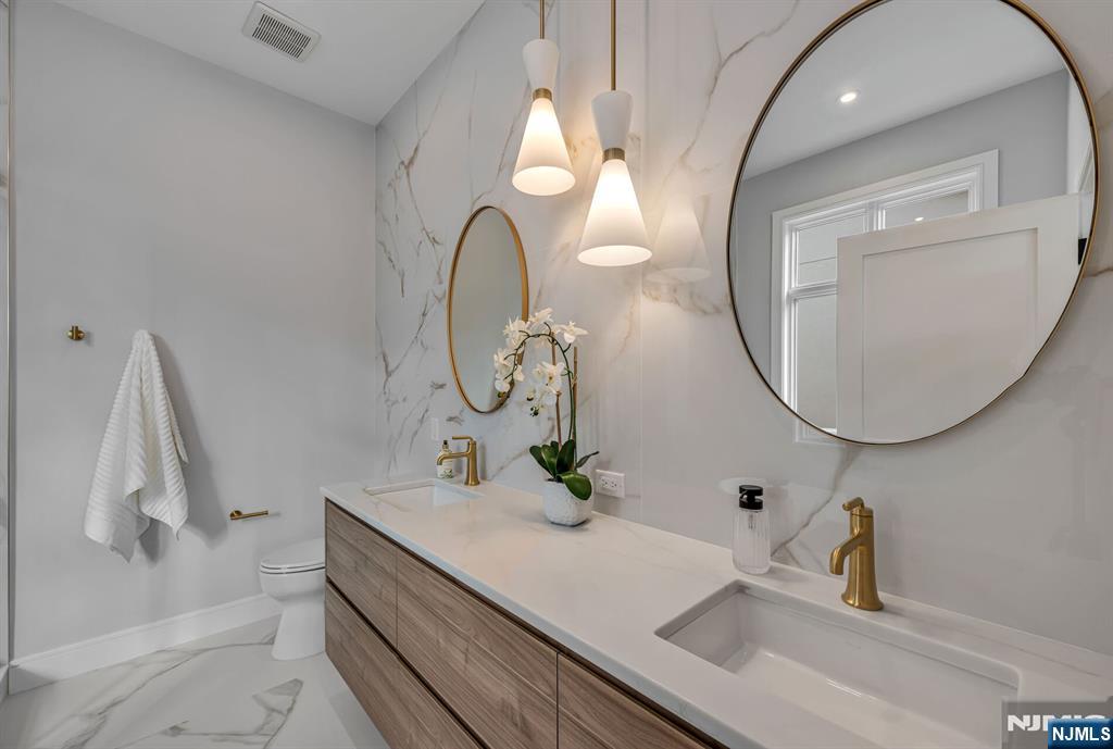 2449 Camner Street Fort Lee, NJ 07024 - Photo 28 of 49 a bathroom with a sink and a mirror