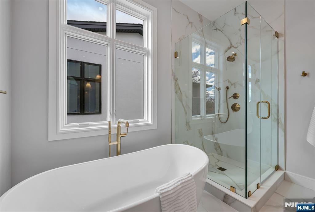 2449 Camner Street Fort Lee, NJ 07024 - Photo 29 of 49 a bathroom with a bathtub and a shower