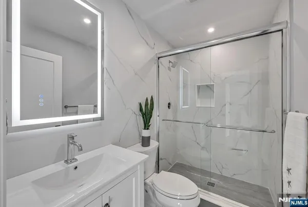 a bathroom with a sink toilet and shower