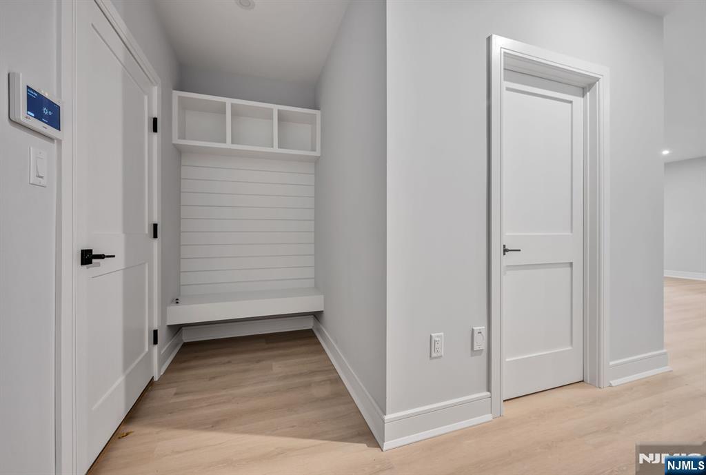 2449 Camner Street Fort Lee, NJ 07024 - Photo 39 of 49 a view of a hallway with wooden floor and closet area