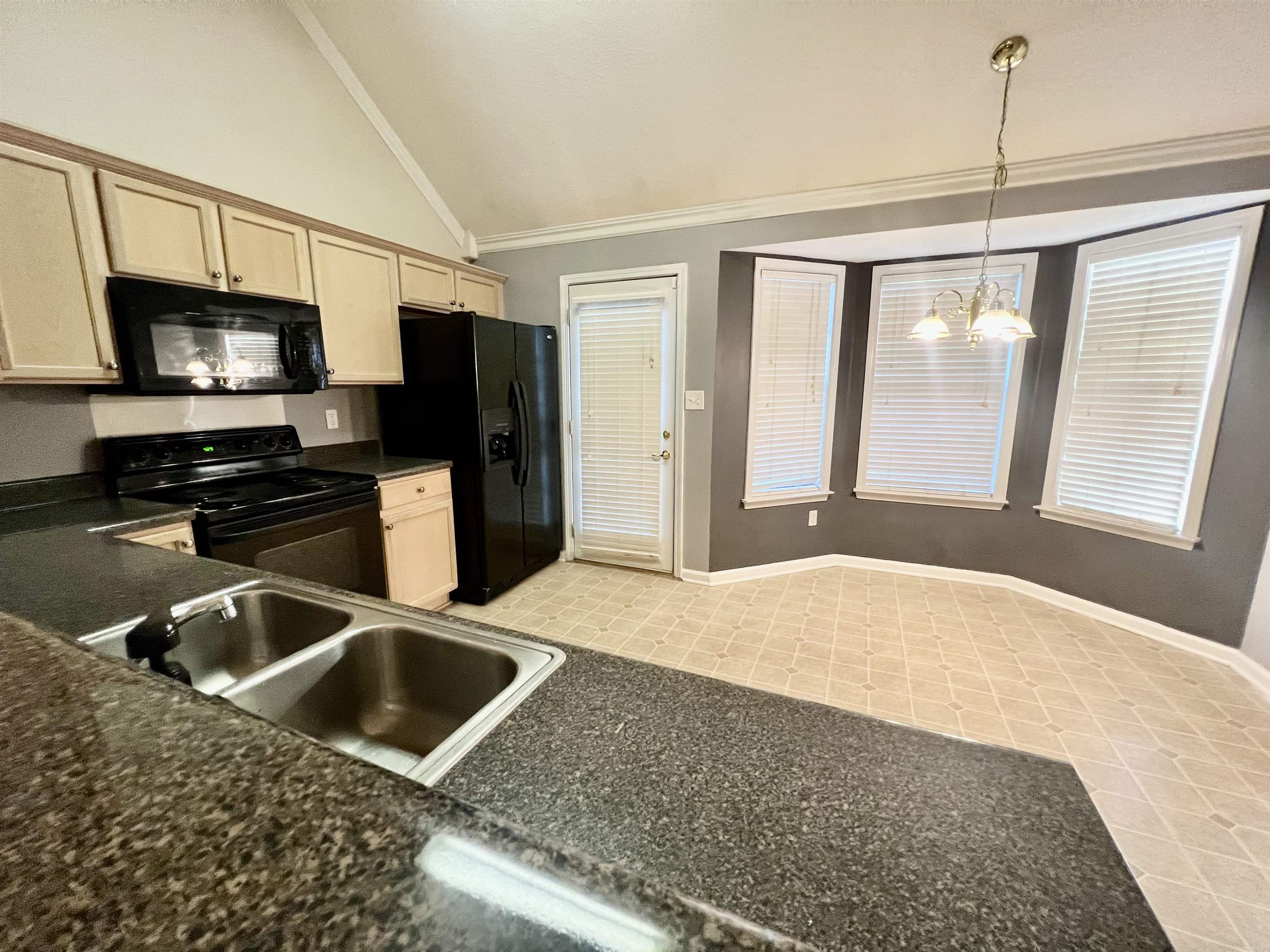 5645 Sycamore Ridge Road Memphis, TN 38134 - Photo 3 of 13 a kitchen with stainless steel appliances granite countertop a sink a stove and a refrigerator