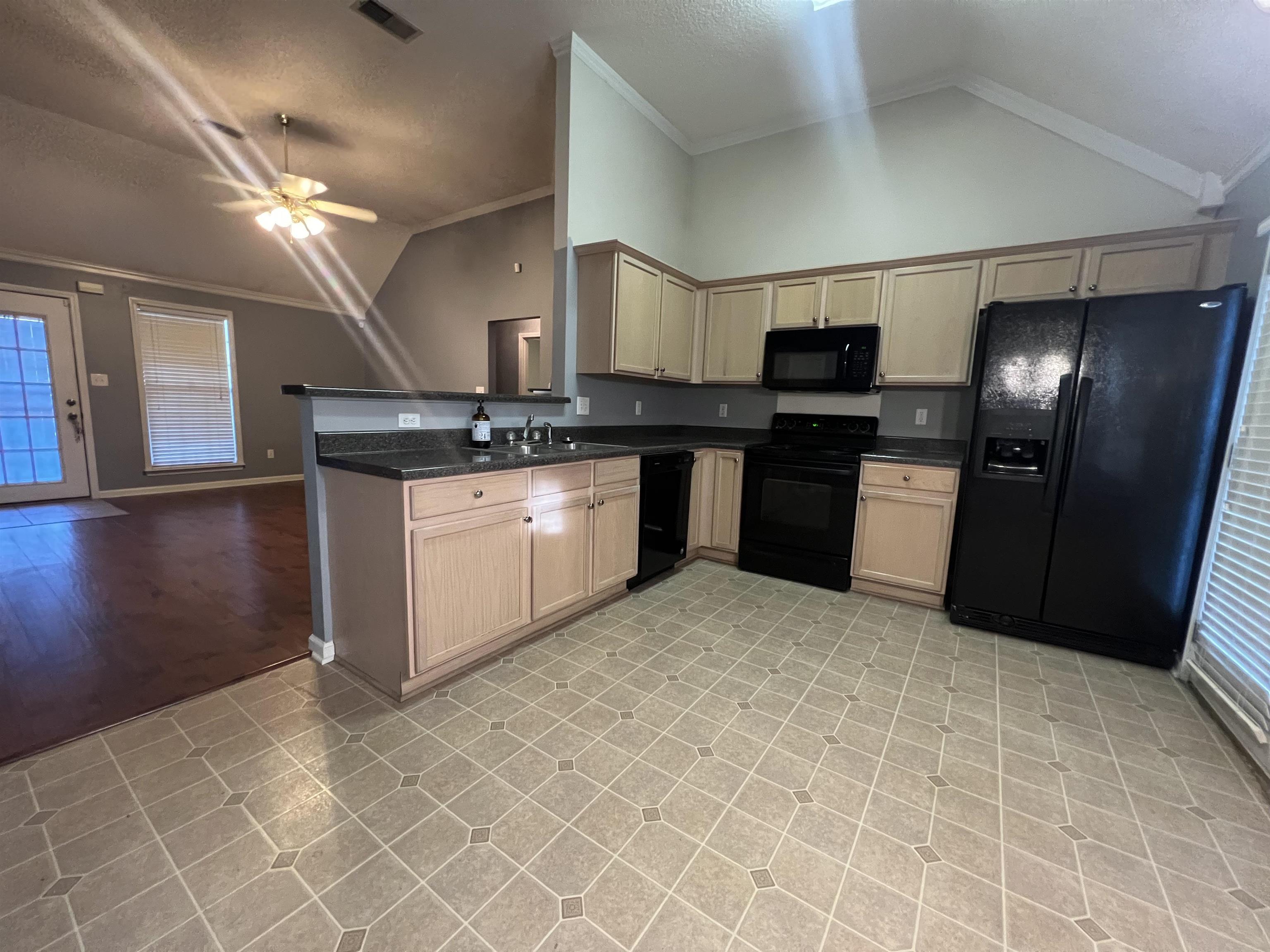 5645 Sycamore Ridge Road Memphis, TN 38134 - Photo 9 of 13 a kitchen with stainless steel appliances granite countertop a sink stove and refrigerator
