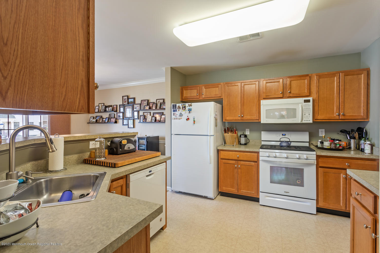 6 Raritan Reach Road, Unit 3 South Amboy, NJ 08879 - Photo 11 of 29 a kitchen with stainless steel appliances granite countertop a refrigerator sink stove and white cabinets