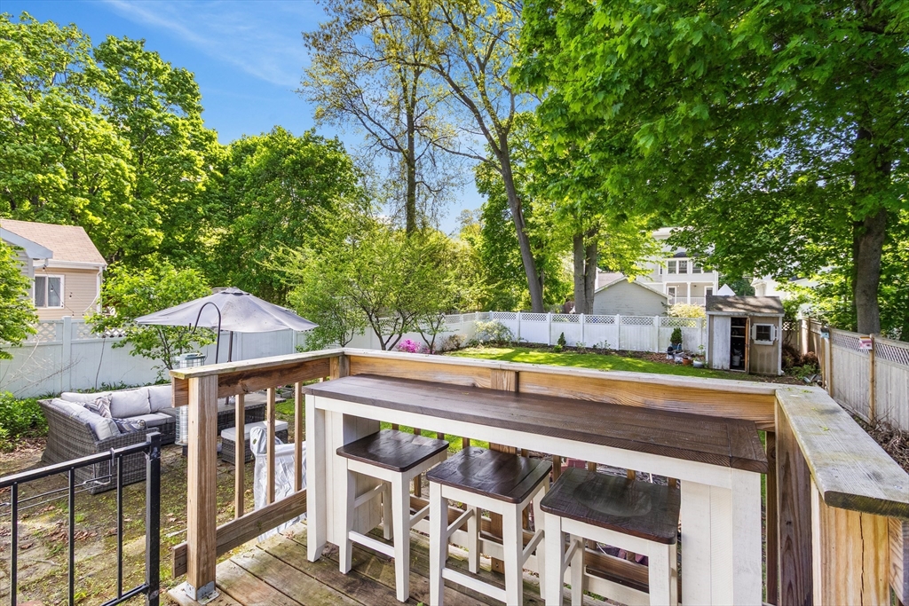 11 Hartlawn Road Boston, MA 02132 - Photo 26 of 34 a view of a chairs and table on the wooden roof deck