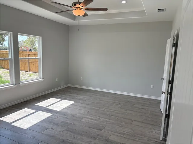 wooden floor in an empty room with a window