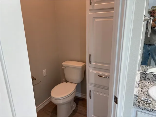 a white toilet sitting next to a shower