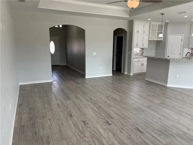 a view of an empty room and wooden floor