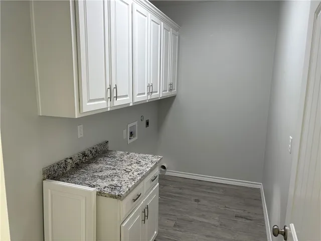 a view of a storage and utility room with granite countertop cabinets