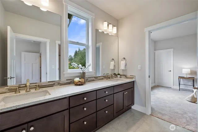 a bathroom with a double vanity sink and a mirror
