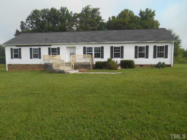 1353 Pixley Pritchard Road Timberlake, NC 27583 - Photo 1 of 12 a front view of a house with a garden and yard