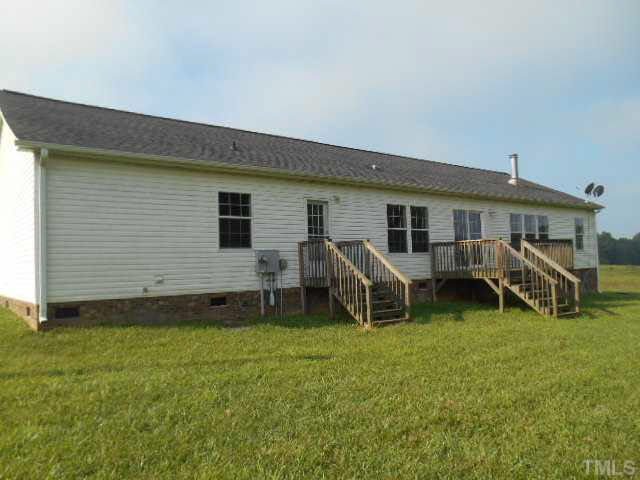1353 Pixley Pritchard Road Timberlake, NC 27583 - Photo 2 of 12 a backyard of a house with table and chairs