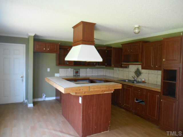 1353 Pixley Pritchard Road Timberlake, NC 27583 - Photo 12 of 12 a kitchen with stainless steel appliances granite countertop a sink stove and refrigerator