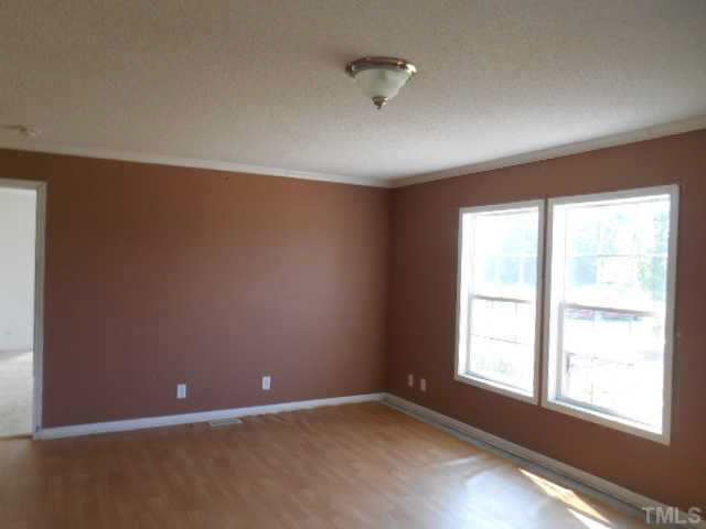 1353 Pixley Pritchard Road Timberlake, NC 27583 - Photo 3 of 12 an empty room with a empty space and a window
