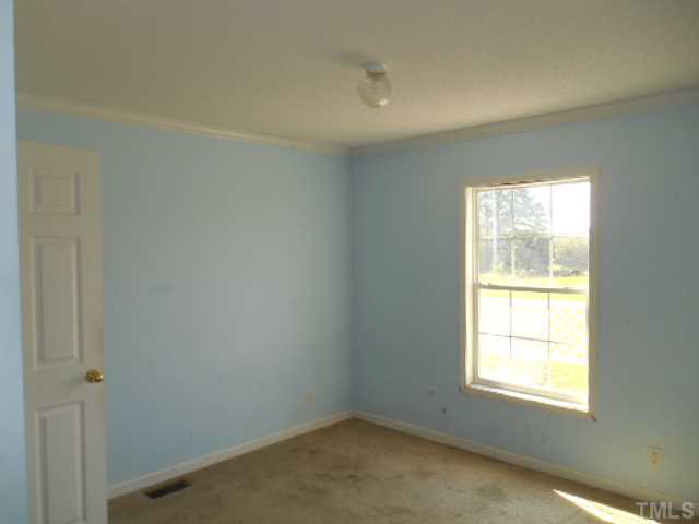 1353 Pixley Pritchard Road Timberlake, NC 27583 - Photo 8 of 12 an empty room with a window