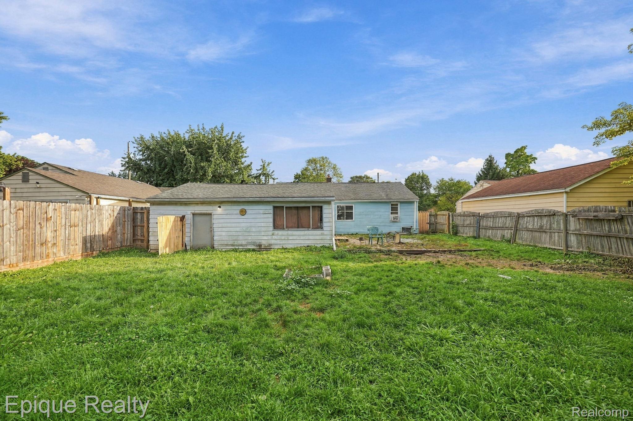 4033 Risedorph Street Burton, MI 48509 - Photo 23 of 25 Expansive grassy yard with wood fencing